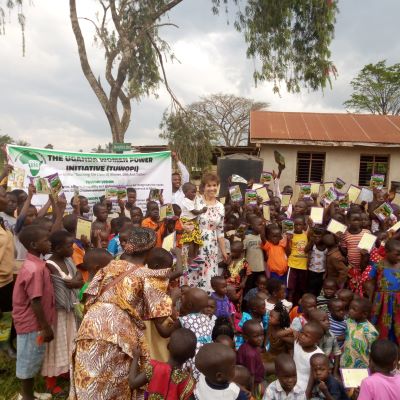 Paula in Uganda with women and children after teaching the women